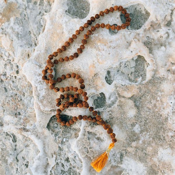 Silhouette of a person meditating against a calm, natural background.